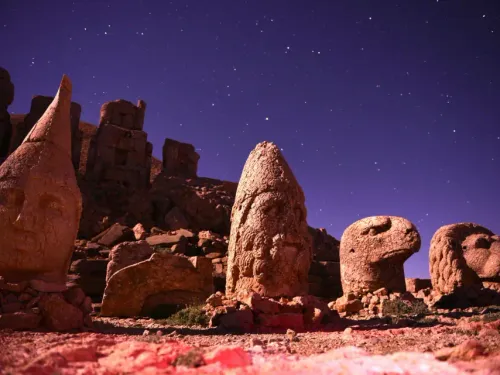 Colossal stone heads of ancient deities resting on the East Terrace of Mount Nemrut at sunrise