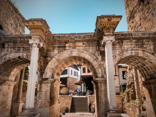 Monumental triple arched marble Hadrian's Gate leading into Antalya's historic Old Town