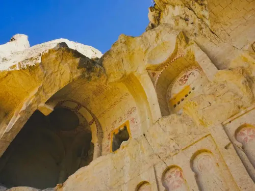 A cave church adorned with Maltese Crosses painted on the soft tufa rock using red ochre painting.