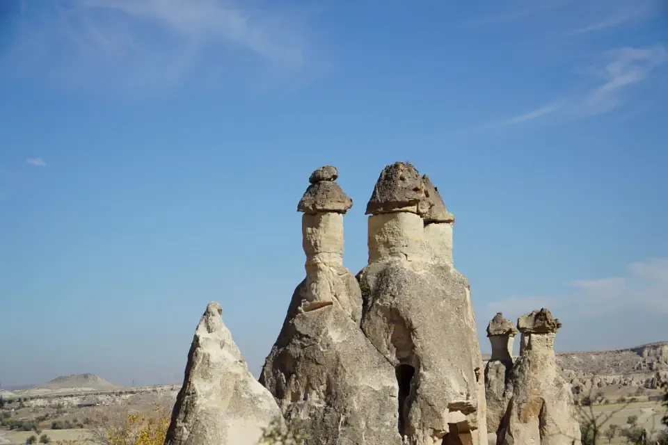 A rare three headed fairy chimney rock formation under a clear sky in Cappadocia