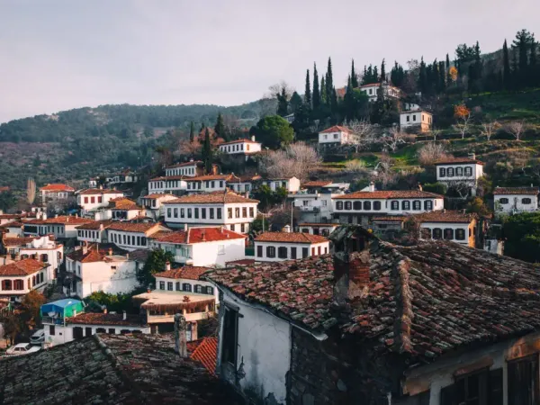 Red tiled roofs and stone houses of Sirince tucked into green Aegean hills