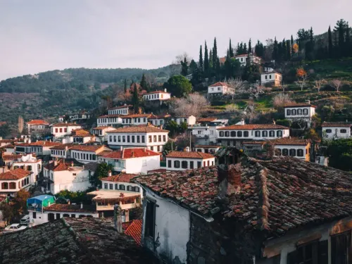 Red tiled roofs and stone houses of Sirince tucked into green Aegean hills
