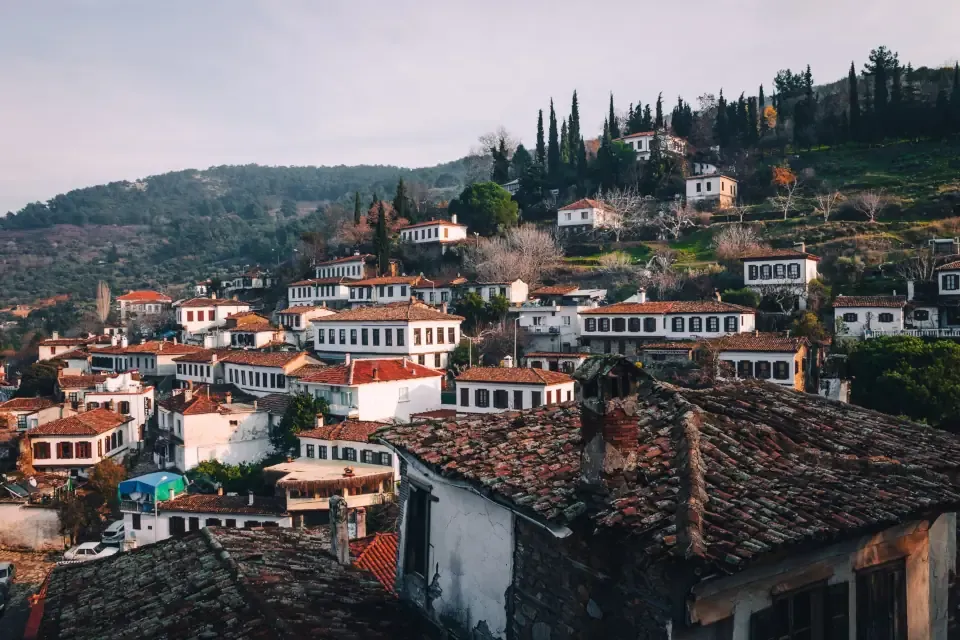 Red tiled roofs and stone houses of Sirince tucked into green Aegean hills