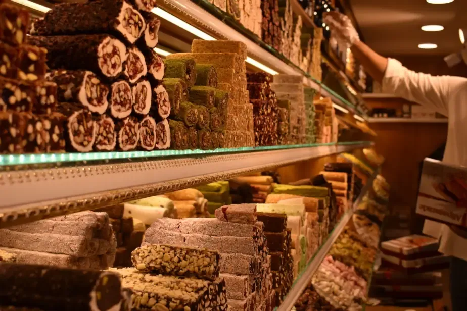 Stacks of fresh gourmet Turkish Delight (Lokum) dusted with powdered sugar and pistachios