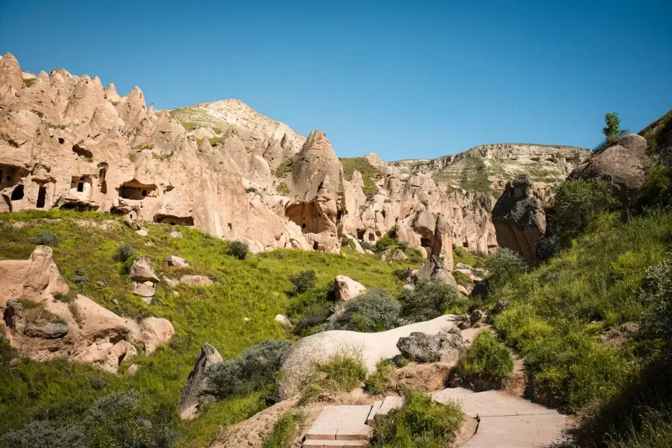 A wide view of the pathways of Zelve Open Air Museum with rock cut openings